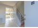 Entryway with staircase and view into kitchen with white cabinets at 3605 W Bethany Home Rd # 10, Phoenix, AZ 85019