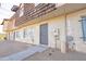 Side view of a tan and brown townhome with a gray door and desert landscaping at 3605 W Bethany Home Rd # 10, Phoenix, AZ 85019