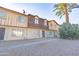 Tan and brown two-story townhome with a walkway and desert landscaping at 3605 W Bethany Home Rd # 10, Phoenix, AZ 85019