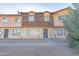Front view of a tan and brown townhome with desert landscaping at 3605 W Bethany Home Rd # 10, Phoenix, AZ 85019