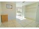 View of a bright, tiled hallway with kitchen and storage visible at 3605 W Bethany Home Rd # 10, Phoenix, AZ 85019