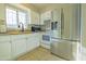 White kitchen cabinets, granite countertops, and stainless steel appliances at 3605 W Bethany Home Rd # 10, Phoenix, AZ 85019