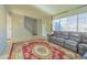 Living room with brown sectional sofa and red area rug near stairs at 3605 W Bethany Home Rd # 10, Phoenix, AZ 85019