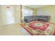 Living room with brown sectional sofa and red area rug near entry at 3605 W Bethany Home Rd # 10, Phoenix, AZ 85019
