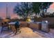 Outdoor kitchen with built-in grill and seating area at 3773 E Donald Dr, Phoenix, AZ 85050