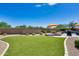 Landscaped backyard with artificial turf and fire pit at 3773 E Donald Dr, Phoenix, AZ 85050