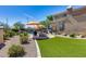 Spacious backyard with pool, fire pit, and built-in BBQ at 3773 E Donald Dr, Phoenix, AZ 85050