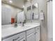 Clean bathroom with single sink, white cabinets, and shower at 3773 E Donald Dr, Phoenix, AZ 85050