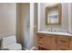 Modern bathroom with a light wood vanity and marble countertop at 3773 E Donald Dr, Phoenix, AZ 85050