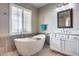 Bathroom with large soaking tub and window at 3773 E Donald Dr, Phoenix, AZ 85050