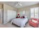 Charming bedroom with a double bed and red accent chair at 3773 E Donald Dr, Phoenix, AZ 85050