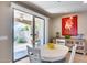 Kitchen dining area with white table and chairs, and access to the backyard at 3773 E Donald Dr, Phoenix, AZ 85050