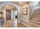 Light and airy entryway with staircase and wood flooring at 3773 E Donald Dr, Phoenix, AZ 85050