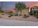 Tan colored house with a tree and desert landscaping in front at 3773 E Donald Dr, Phoenix, AZ 85050
