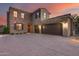 Two-story home with stone facade, double car garage, and desert landscaping at 3773 E Donald Dr, Phoenix, AZ 85050