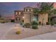 Two-story home with stone and stucco exterior, landscaped yard, and welcoming entryway at 3773 E Donald Dr, Phoenix, AZ 85050