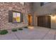 Front view of home with stone accents, double-door garage, and desert landscaping at 3773 E Donald Dr, Phoenix, AZ 85050