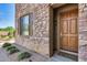 Elegant front door with stone entryway and landscaping at 3773 E Donald Dr, Phoenix, AZ 85050