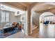 Bright hallway with arched doorways leading to a den and stairs at 3773 E Donald Dr, Phoenix, AZ 85050