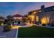Two-story house exterior with backyard and pool at dusk at 3773 E Donald Dr, Phoenix, AZ 85050