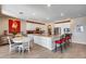 Open kitchen with island and seating, plus adjacent dining area at 3773 E Donald Dr, Phoenix, AZ 85050