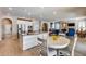 Open concept kitchen with island and seating area overlooking living room at 3773 E Donald Dr, Phoenix, AZ 85050