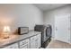 Laundry room with washer, dryer, and built-in cabinets at 3773 E Donald Dr, Phoenix, AZ 85050