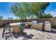 Luxury outdoor kitchen with grill and bar seating at 3773 E Donald Dr, Phoenix, AZ 85050