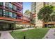 Modern condo courtyard with lush green landscaping and benches at 4808 N 24Th St # 627, Phoenix, AZ 85016