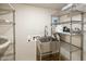 Laundry room with stainless steel sink and ample shelving at 4808 N 24Th St # 627, Phoenix, AZ 85016