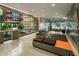 Modern condo lobby with orange and gray seating, and views to courtyard at 4808 N 24Th St # 627, Phoenix, AZ 85016