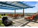 Relaxing rooftop deck with city views, tables, chairs, and lounge chairs at 4808 N 24Th St # 627, Phoenix, AZ 85016