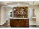 Modern wet bar with glass tile backsplash and cabinetry at 4808 N 24Th St # 627, Phoenix, AZ 85016