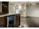 Wet bar with built-in beverage cooler and cabinetry at 4808 N 24Th St # 627, Phoenix, AZ 85016