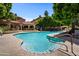 Inviting community pool with surrounding lounge chairs and landscaping at 5104 N 32Nd St # 417, Phoenix, AZ 85018