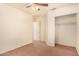 Spacious bedroom with brown carpet, a ceiling fan, and a large closet at 524 N Leoma Ln, Chandler, AZ 85225
