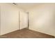 Simple bedroom with brown carpet, ceiling fan, and ample closet space at 524 N Leoma Ln, Chandler, AZ 85225