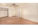 Bright bedroom featuring brown carpet, a ceiling fan and sliding door closet at 524 N Leoma Ln, Chandler, AZ 85225