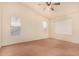 Spacious bedroom with ceiling fan and neutral carpeting at 524 N Leoma Ln, Chandler, AZ 85225