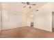 Bright bedroom with ceiling fan and access to bathroom at 524 N Leoma Ln, Chandler, AZ 85225