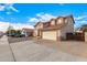 Two-story house with beige exterior, two-car garage, and a gated driveway at 524 N Leoma Ln, Chandler, AZ 85225