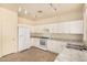 Modern kitchen with white cabinets and granite countertops at 524 N Leoma Ln, Chandler, AZ 85225