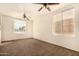 Bright living room with large windows, carpeting, and ceiling fans at 524 N Leoma Ln, Chandler, AZ 85225