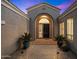 Elegant entryway with arched doorway and well-manicured courtyard at 5473 E Herrera Dr, Phoenix, AZ 85054