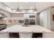 Modern kitchen with white cabinets, large island, and stainless steel appliances at 5473 E Herrera Dr, Phoenix, AZ 85054