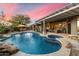 Inviting pool and spa area with a pergola and comfortable seating at 5473 E Herrera Dr, Phoenix, AZ 85054