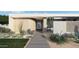 Mid-century modern home with landscaped yard and walkway at 7034 E Paradise Dr, Scottsdale, AZ 85254