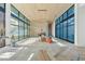 Spacious living room with large windows and stone fireplace, currently under construction at 7034 E Paradise Dr, Scottsdale, AZ 85254