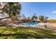 Community swimming pool with lounge chairs and shaded seating at 812 E Joan De Arc Ave, Phoenix, AZ 85022