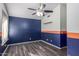 Bedroom with dark blue and orange accent walls at 8630 W Melinda Ln, Peoria, AZ 85382